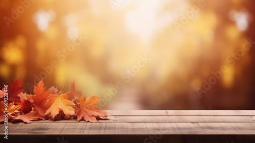 empty wooden table with blurry autumn background