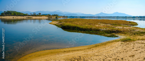 Daegu City nature landscape in autumn, tranquil riverbank, curving sand bars, and mountain views over the wildlife conservation area in Nakdong River, South Korea