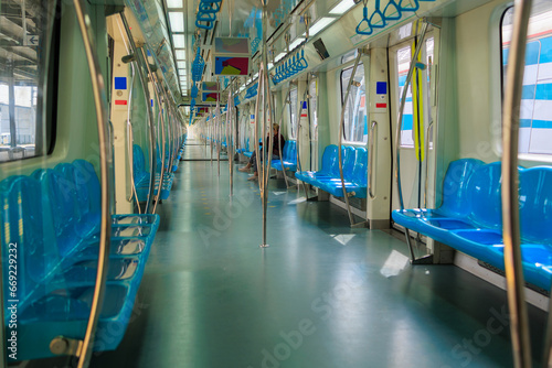 Photography Subway train carriage, interior with blue seats and handrails