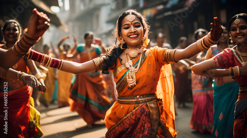 Charming Indian women dancing on the streets in traditional dresses photo