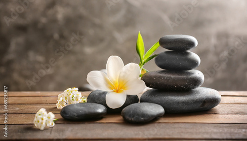 spa stones and white flower on table