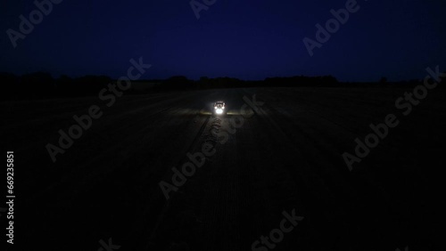 Baling hay on the wheat field during the harvest season photo
