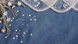 abstract blue denim background with silver sequins and lace