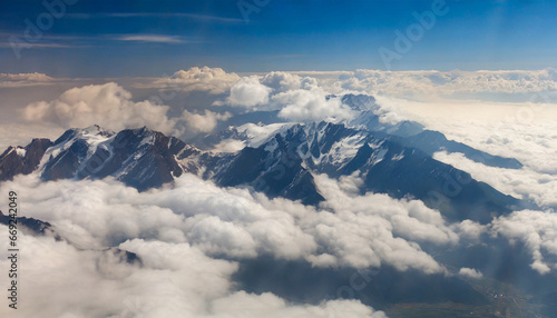 a view of a mountain range in the clouds from a plane generative ai © Alicia