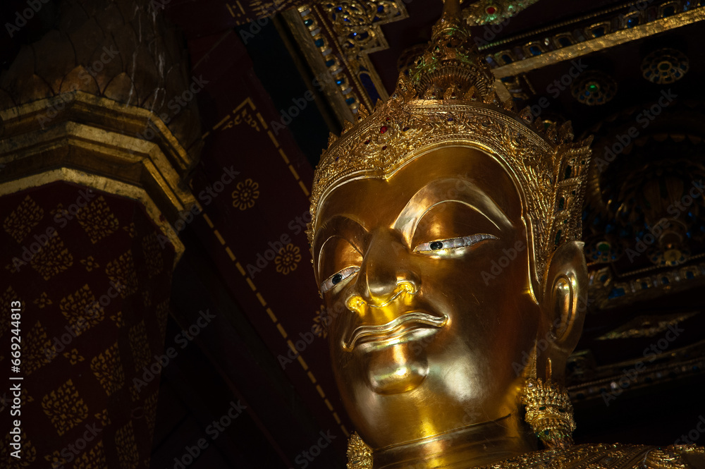 Close of golden buddha image of Wat Na Phra Men with space on right