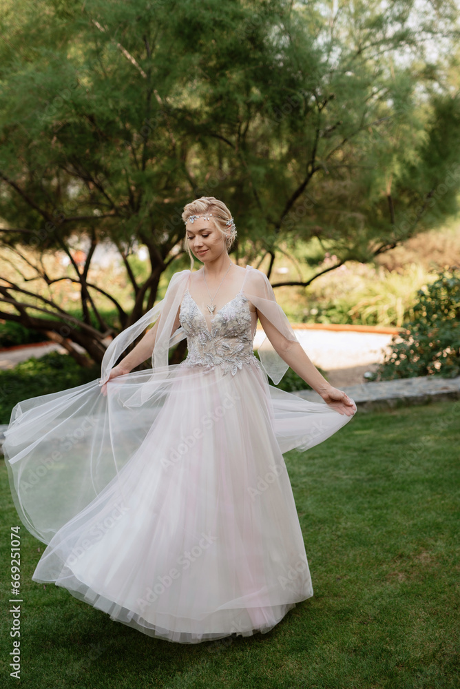 portrait of a happy bride in a light light dress in  wearing elven accessories