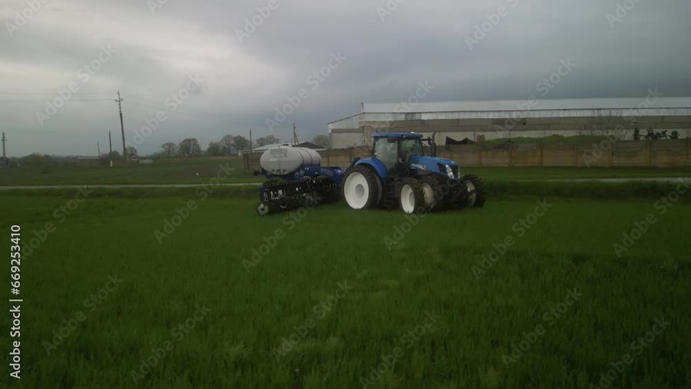 Tactor on the field doing liquid fertilizer injection Tactor on the field doing liquid fertilizer injection