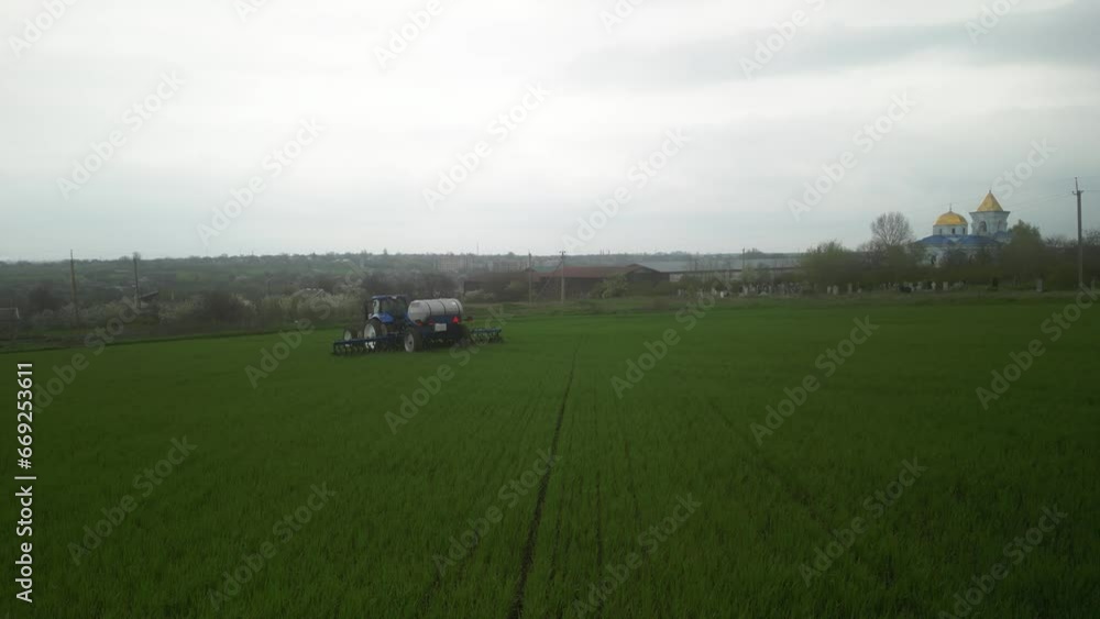 Tactor on the field doing liquid fertilizer injection Tactor on the field doing liquid fertilizer injection