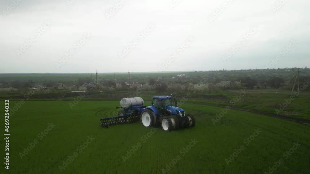 Tactor on the field doing liquid fertilizer injection Tactor on the field doing liquid fertilizer injection