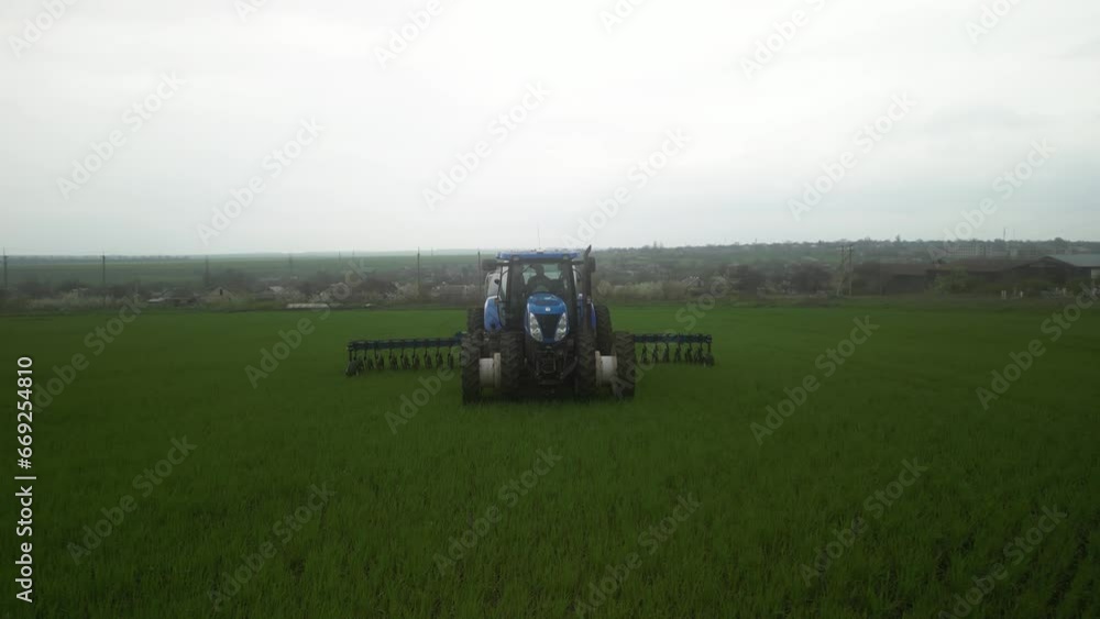 Tactor on the field doing liquid fertilizer injection Tactor on the field doing liquid fertilizer injection
