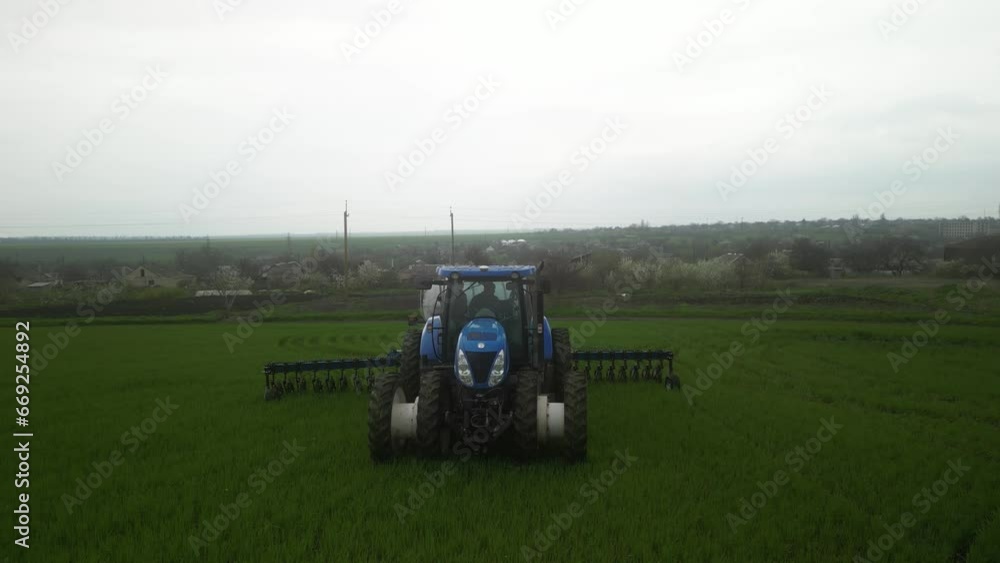 Tactor on the field doing liquid fertilizer injection Tactor on the field doing liquid fertilizer injection
