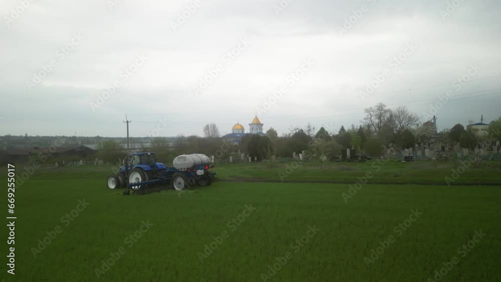 Tactor on the field doing liquid fertilizer injection Tactor on the field doing liquid fertilizer injection