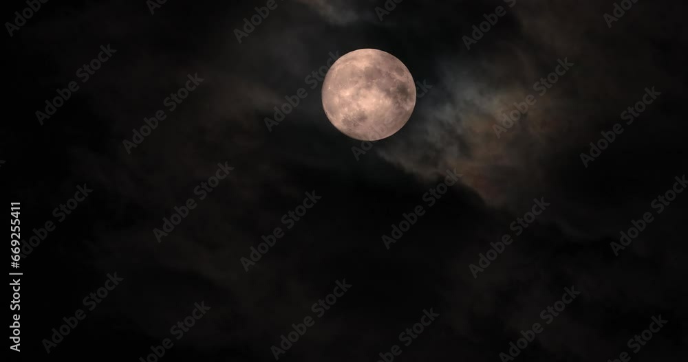Yellow full moon in the cloudy evening sky Yellow full moon in the cloudy evening sky