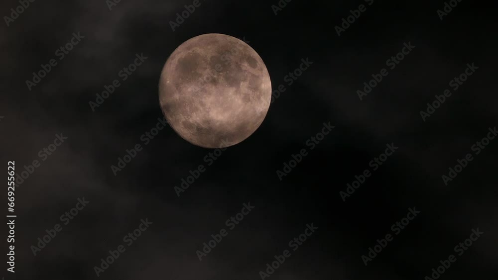 Yellow full moon in the cloudy evening sky Yellow full moon in the cloudy evening sky