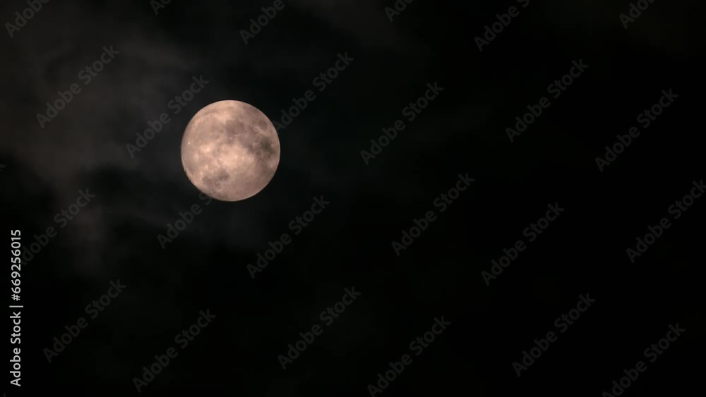 Yellow full moon in the cloudy evening sky Yellow full moon in the cloudy evening sky