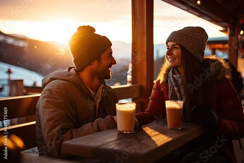 A happy, young couple enjoys a romantic winter outdoor date, sipping coffee and sharing love and laughter. photo