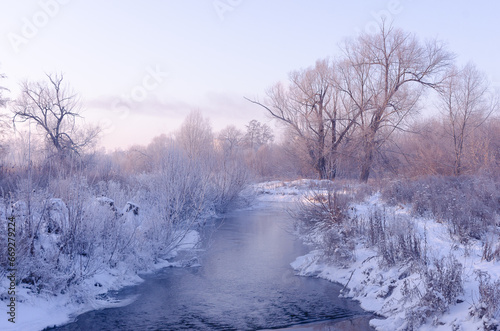 Winter landscape, frosty early morning on the river. Snow on the trees and frost. © Ruslan