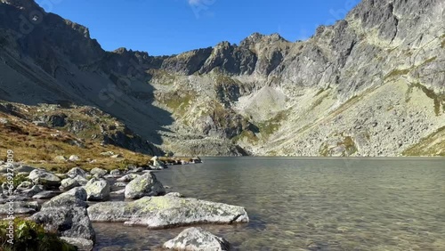 Lake Hincovo pleso in a canyon on top of a mountain in Slovakia on a clear sunny day