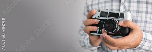 man holding vintage camera