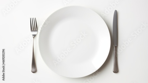 Empty white plate with fork and knife on white background  top view