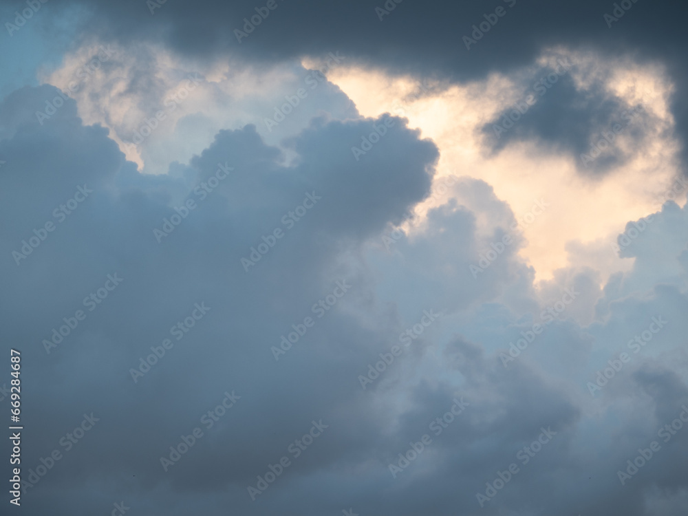Blue sky after rain,. Beautiful Cumulus clouds flying across the sky, sunset rays, pink and orange shades in the clouds, deep blue sky Blue sky after rain,. Beautiful Cumulus clouds flying across the sky, sunset rays, pink and orange shades in the clouds, deep blue sky