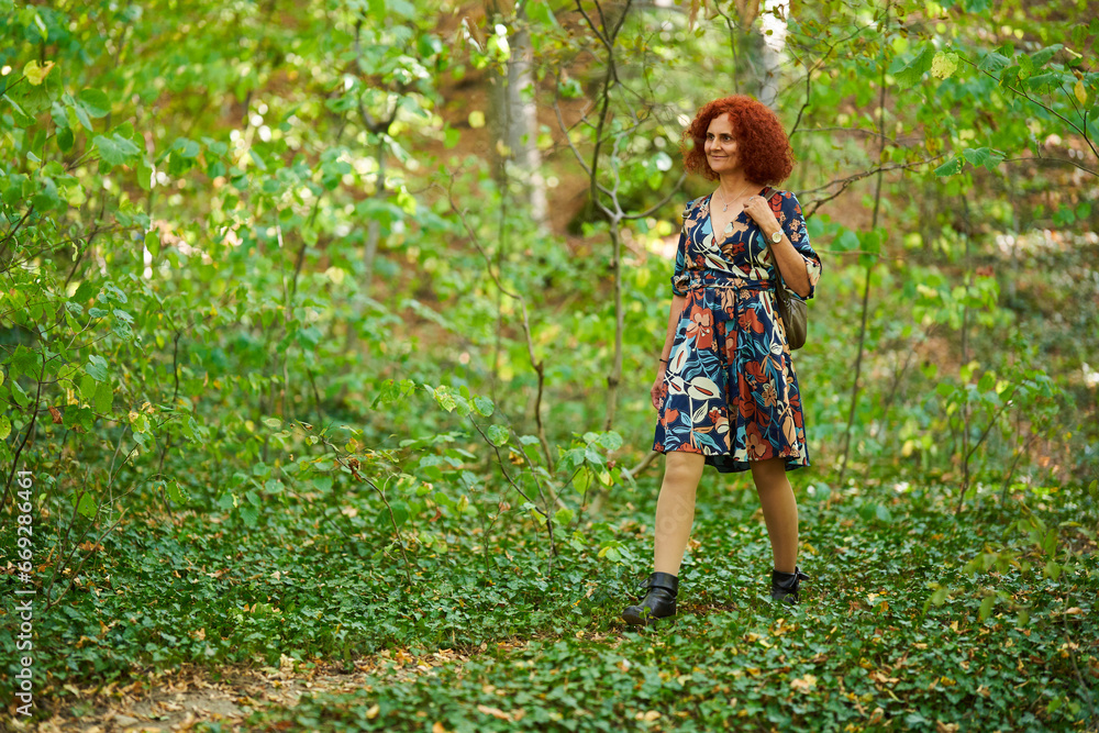 Curly redhead lady in the park Curly redhead lady in the park