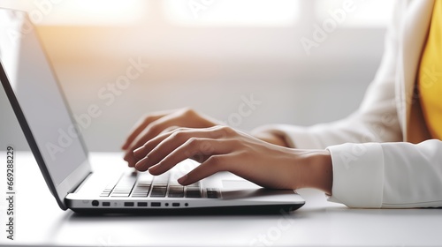 Hands Typing On A Laptop Keyboard In Close-Up View On A White Table At The Office To Work Online