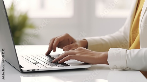 Hands Typing On A Laptop Keyboard In Close-Up View On A White Table At The Office To Work Online