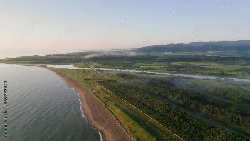 Coastal road over river in green misty landscape in morning light Coastal road over river in green misty landscape in morning light