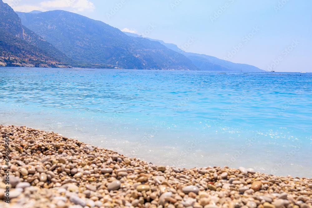 View of the mountains and the sea from Oludeniz beach, the blue lagoon. The cleanest beach with blue flag. Background View of the mountains and the sea from Oludeniz beach, the blue lagoon. The cleanest beach with blue flag. Background