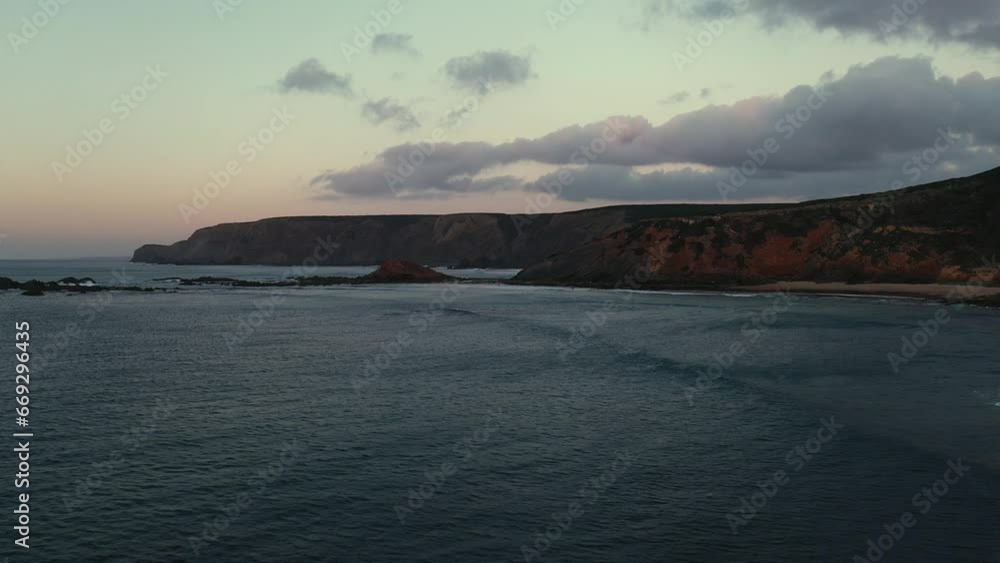 Big waves rolling in the coastline of the Southwestern Algarve, Portugal.
The sunset reflects along the cliffs while showing colorful and high contrast on the rocky shoreline. Big waves rolling in the coastline of the Southwestern Algarve, Portugal.
The sunset reflects along the cliffs while showing colorful and high contrast on the rocky shoreline.
