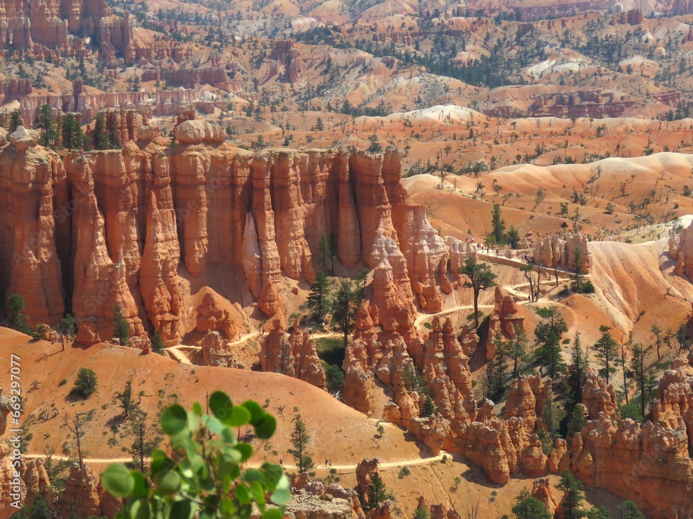 Bryce Canyon National Park, Utah, USA. The red geological formations of the hoodoos and orange slopes are revealed in all their beauty to curious tourists walking along the trails of Bryce Canyon. Bryce Canyon National Park, Utah, USA. The red geological formations of the hoodoos and orange slopes are revealed in all their beauty to curious tourists walking along the trails of Bryce Canyon.