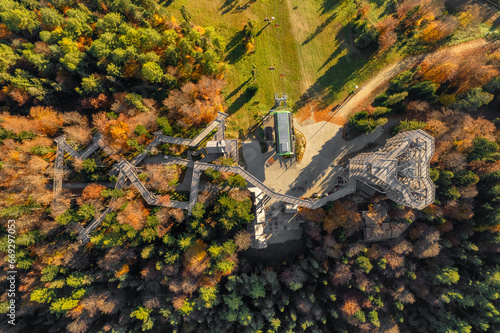 Fototapeta Naklejka Na Ścianę i Meble -  Tree top observation tower in resort town Krynica-Zdroj at sunrise, Poland