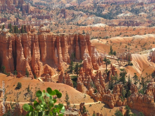 Bryce Canyon National Park, Utah, USA. The red geological formations of the hoodoos and orange slopes are revealed in all their beauty to curious tourists walking along the trails of Bryce Canyon. 