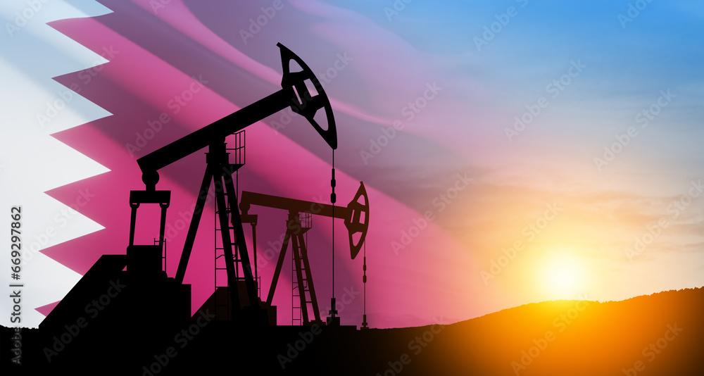 Oil drilling derricks at desert oilfield with Qatar flag.