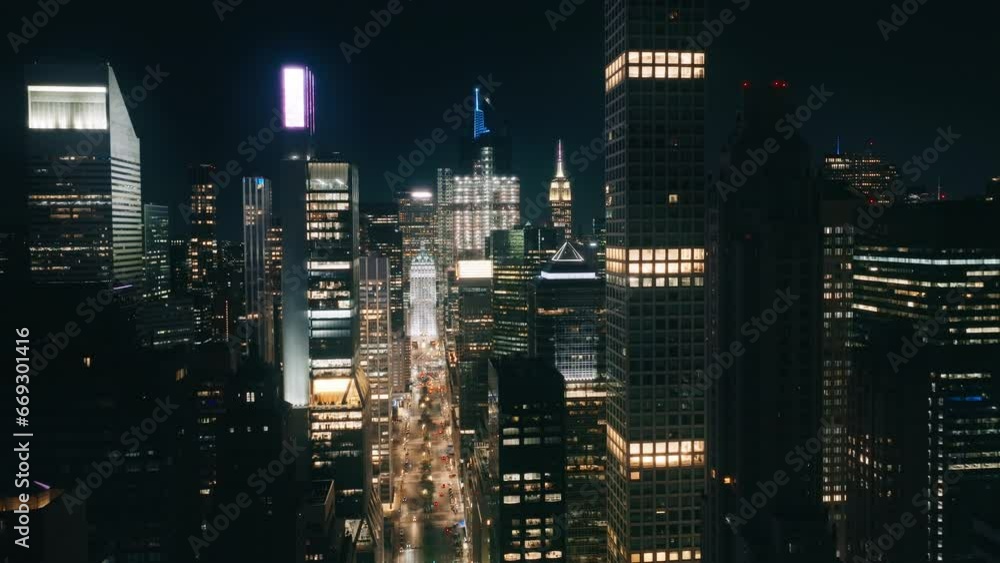Scenic view of urban canyon street road on Manhattan with busy car traffic. Cinematic city lights at dark night. NYC illumination. Aerial birds eye perspective of New York City skyscrapers at night 4K Scenic view of urban canyon street road on Manhattan with busy car traffic. Cinematic city lights at dark night. NYC illumination. Aerial birds eye perspective of New York City skyscrapers at night 4K