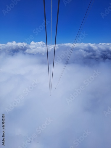 The mountains are hidden by a thick white cloud, a view from inside the cab of the cable car on the Zugspitze mountain height -2962 m. in Bavaria, Germany