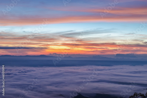 Misty morning light and colorful cloudy mountain valley landscape Dawn  fog between mountain ranges 