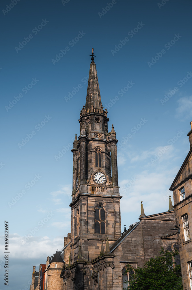 Tower of old church in Edinburgh, Scotland old town against blue sky. Medieval architecture