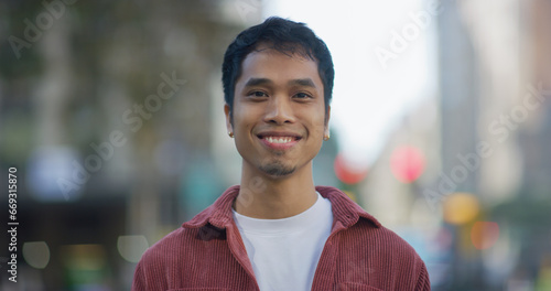 Tableau sur toile Young Filipino man smile face portrait on city street