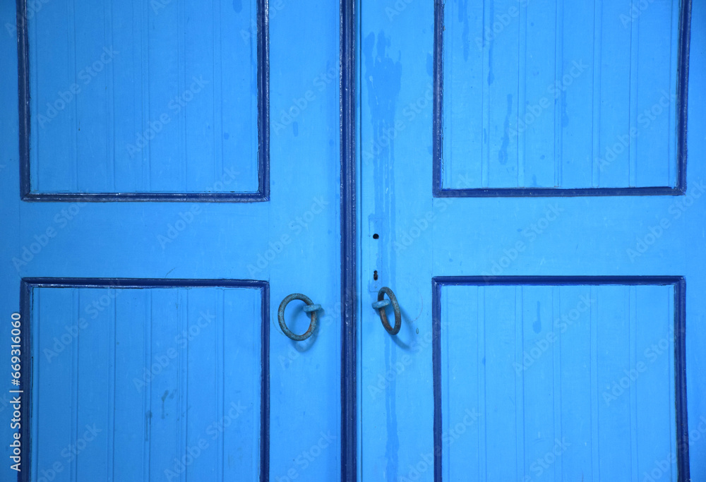 Detail of an ancient door ornament with a royal pattern in Java, Indonesia, which is dominated by blue Detail of an ancient door ornament with a royal pattern in Java, Indonesia, which is dominated by blue