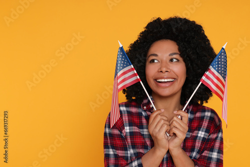4th of July - Independence Day of USA. Happy woman with American flags on yellow background, space for text