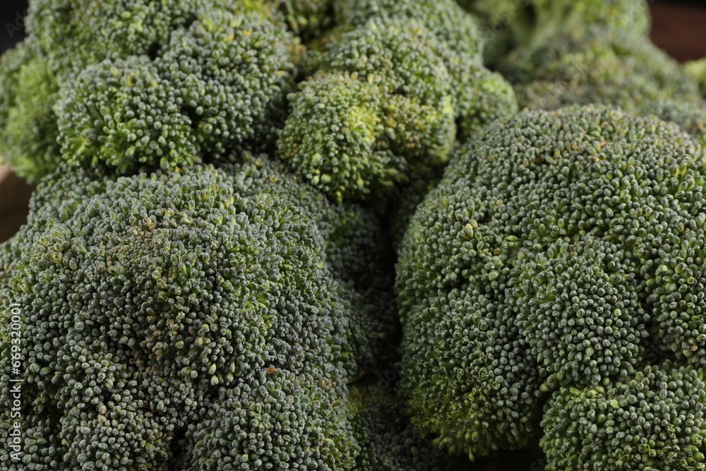 Fresh raw green broccoli on blurred background, closeup Fresh raw green broccoli on blurred background, closeup