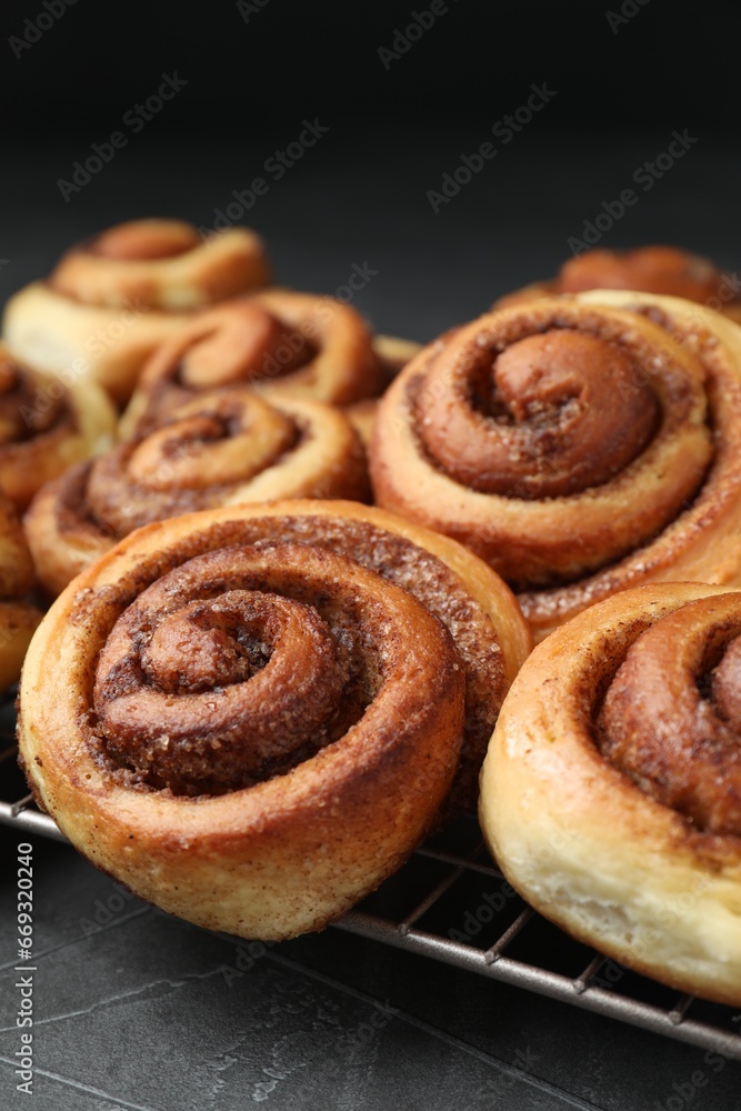 Tasty cinnamon rolls on black table, closeup Tasty cinnamon rolls on black table, closeup