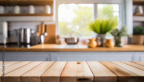 Selective focus.Wood table top on blur kitchen counter in morning background.For montage product display