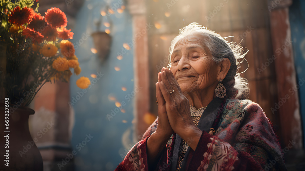 Elderly woman with intricate earrings, praying serenely beside a vase of vibrant marigold flowers against a rustic backdrop