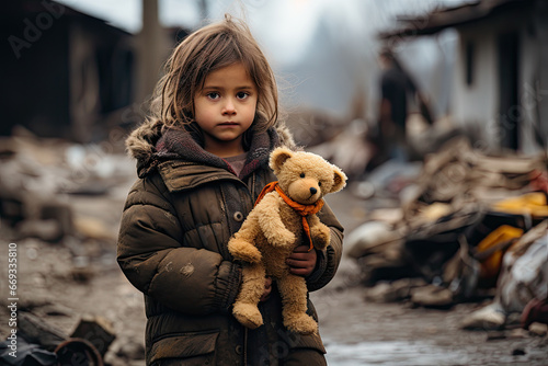 a little girl holding a teddy bear in front of the rubble - covered area that has been destroyed by fire
