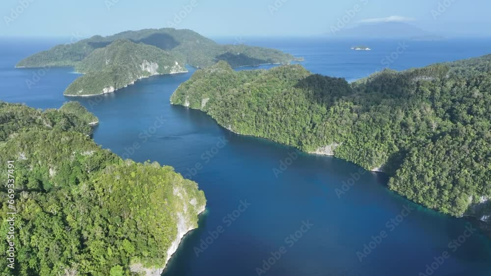 Limestone islands rise from Alyui Bay, a large body of water in Waigeo Island in Raja Ampat. This area is known as the heart of the Coral Triangle due to its incredible marine biodiversity. Limestone islands rise from Alyui Bay, a large body of water in Waigeo Island in Raja Ampat. This area is known as the heart of the Coral Triangle due to its incredible marine biodiversity.