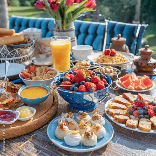 BREAKFAST BUFFET TABLE FILLED WITH ASSORTED FOODS