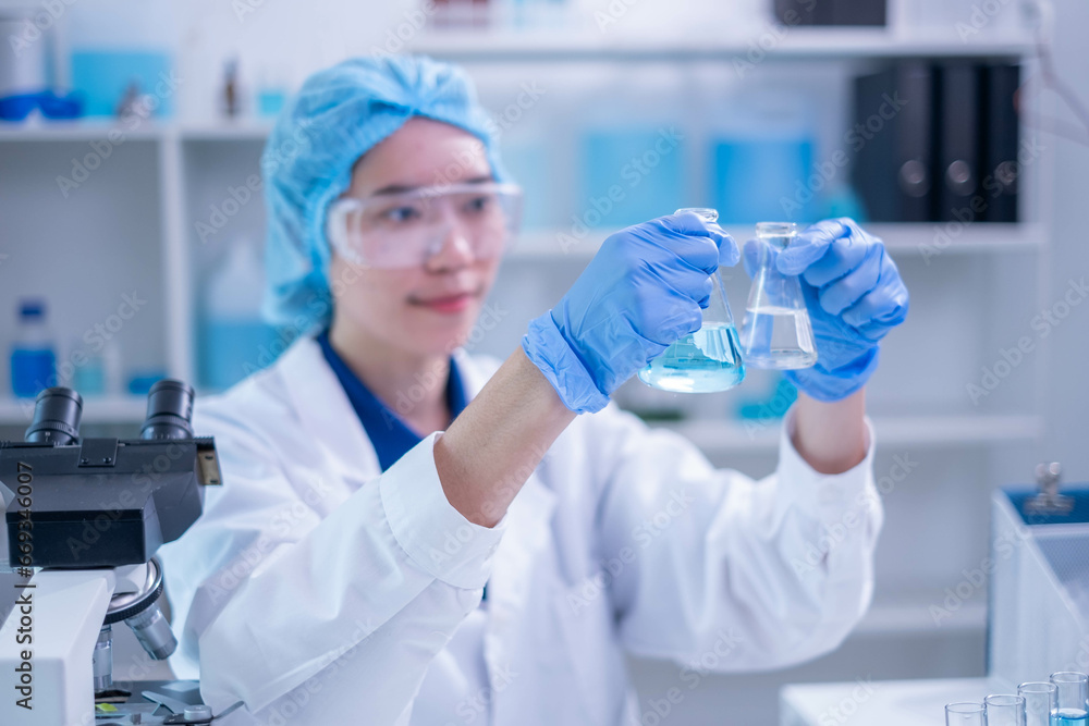 Fototapeta premium Professional expertise woman research scientist compare blue liquid in test tube or glassware beaker in chemical scientific experiment laboratory, female doctor pharmacy biology medicine person